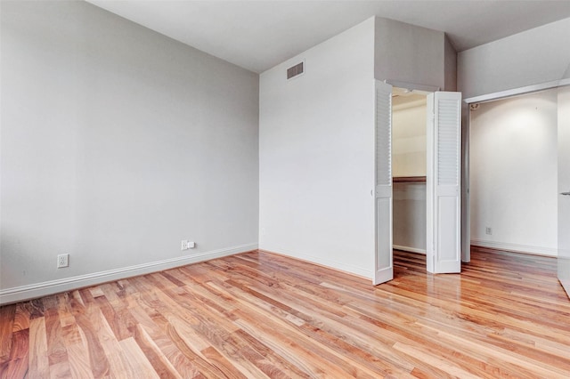 49 Briar Hollow Ln Unit 1801, Houston, TX 77027 - unfurnished bedroom featuring wood finished floors and a closet