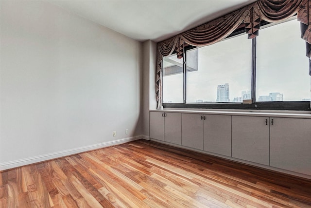 49 Briar Hollow Ln Unit 1801, Houston, TX 77027 - empty room featuring light wood finished floors and baseboards