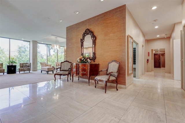 49 Briar Hollow Ln Unit 1801, Houston, TX 77027 - corridor with floor to ceiling windows, light tile patterned floors, recessed lighting, and a chandelier