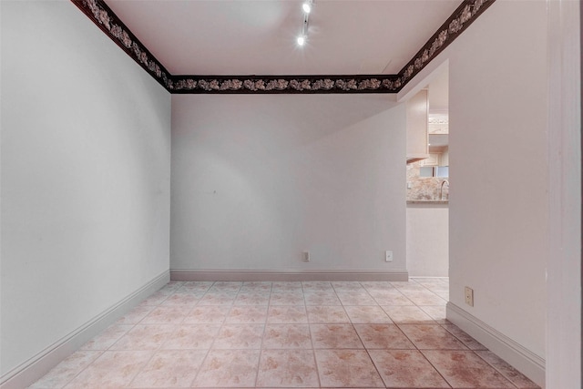 49 Briar Hollow Ln Unit 1801, Houston, TX 77027 - spare room with rail lighting and light tile patterned flooring
