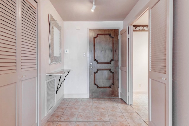 49 Briar Hollow Ln Unit 1801, Houston, TX 77027 - hall featuring light tile patterned floors and baseboards