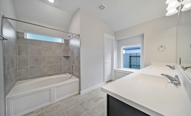 4446 Azalea Blossom Rd, Pinehurst, TX 77362 - full bath with healthy amount of natural light, shower / bath combination, vanity, lofted ceiling, and tile patterned floors