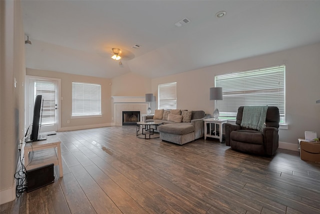 10527 Friars Hl, Houston, TX 77070 - living room featuring dark wood-style floors, healthy amount of natural light, a tiled fireplace, and vaulted ceiling