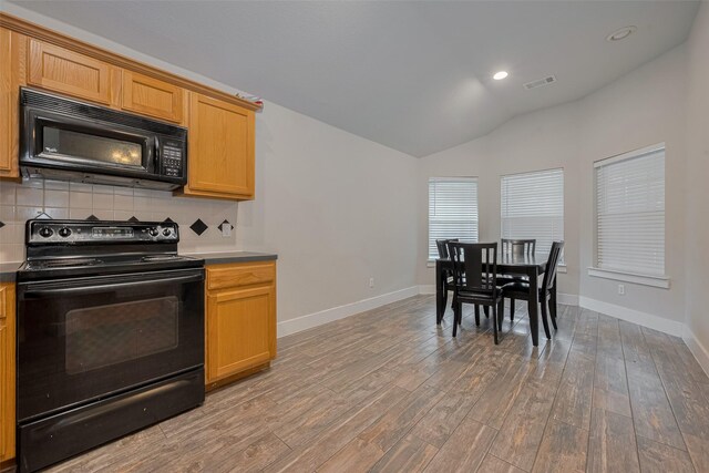 10527 Friars Hl, Houston, TX 77070 - kitchen featuring black appliances, tasteful backsplash, vaulted ceiling, light wood-style floors, and recessed lighting