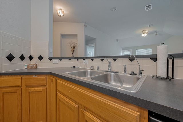 10527 Friars Hl, Houston, TX 77070 - kitchen featuring backsplash, dark countertops, and brown cabinets