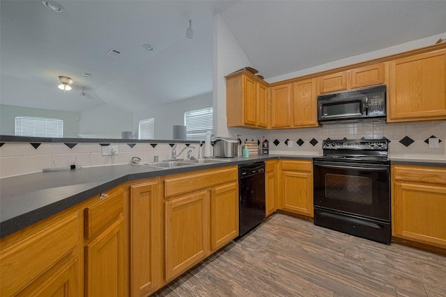 10527 Friars Hl, Houston, TX 77070 - kitchen featuring black appliances, vaulted ceiling, decorative backsplash, wood finished floors, and dark countertops