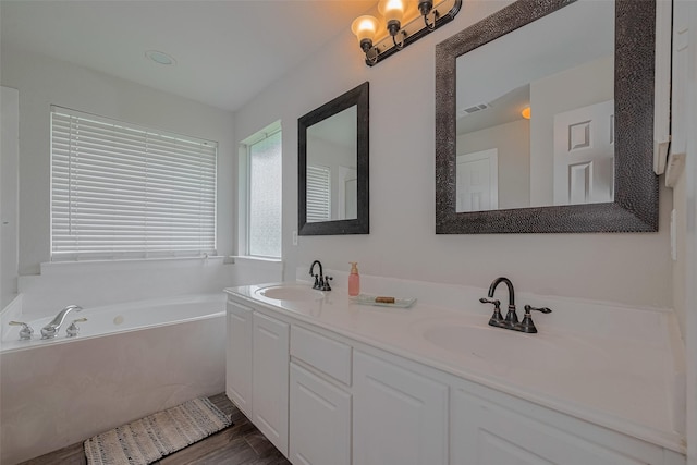 10527 Friars Hl, Houston, TX 77070 - full bath featuring double vanity, a bath, and wood finished floors