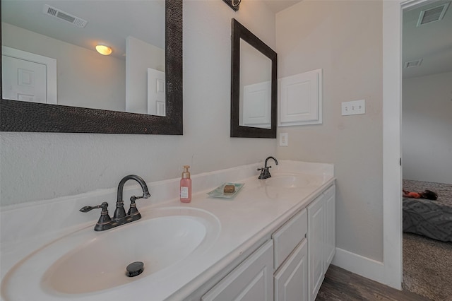 10527 Friars Hl, Houston, TX 77070 - full bathroom featuring double vanity, wood finished floors, and ensuite bath