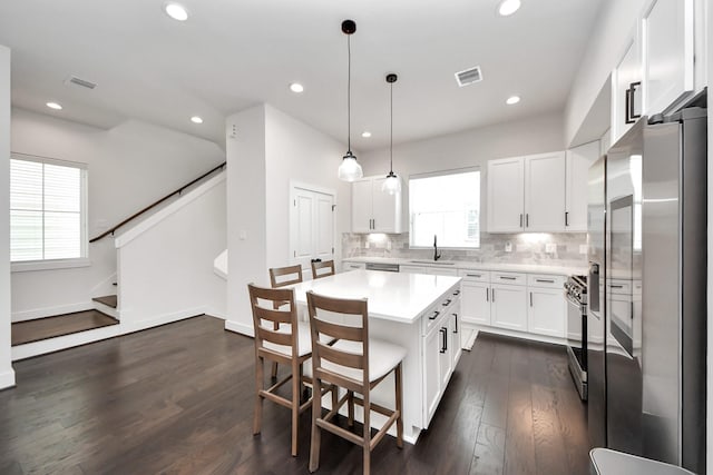5502 Wheatley St Unit B, Houston, TX 77091 - kitchen featuring stainless steel appliances, light countertops, white cabinetry, decorative backsplash, and recessed lighting
