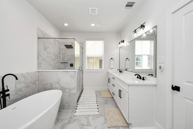 5502 Wheatley St Unit B, Houston, TX 77091 - full bath with a freestanding bath, healthy amount of natural light, double vanity, a stall shower, and recessed lighting