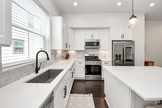 5502 Wheatley St Unit B, Houston, TX 77091 - kitchen with appliances with stainless steel finishes, tasteful backsplash, white cabinetry, light countertops, and recessed lighting