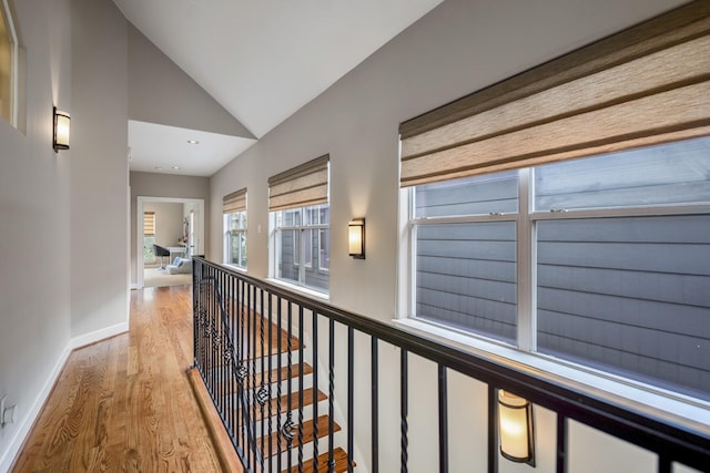 1013 Crocker St, Houston, TX 77019 - hallway with vaulted ceiling, wood finished floors, and an upstairs landing