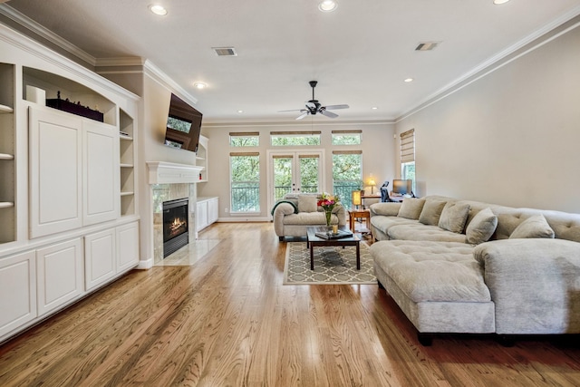 1013 Crocker St, Houston, TX 77019 - living room with ceiling fan, crown molding, a premium fireplace, light wood-type flooring, and recessed lighting