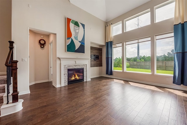 14062 Dunsmore Landing Dr, Houston, TX 77059 - unfurnished living room with high vaulted ceiling, healthy amount of natural light, dark wood finished floors, and a fireplace
