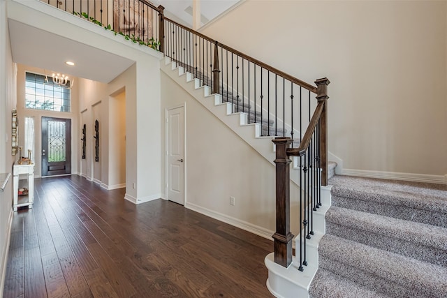 14062 Dunsmore Landing Dr, Houston, TX 77059 - entryway featuring dark wood finished floors, stairway, a high ceiling, and a chandelier