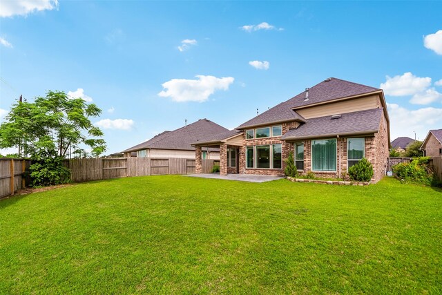 14062 Dunsmore Landing Dr, Houston, TX 77059 - back of house with a patio area, brick siding, a fenced backyard, and a shingled roof