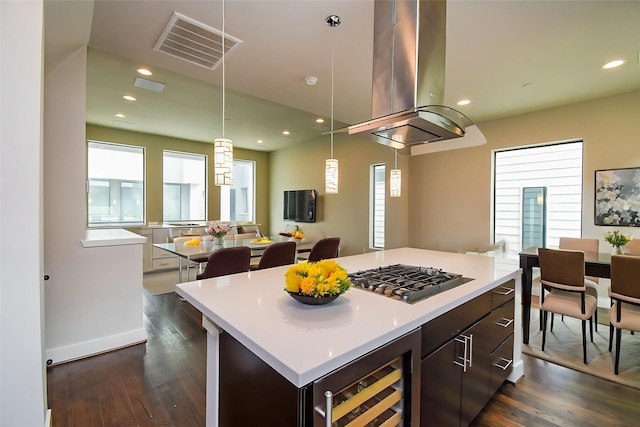 5638 Petty St Unit B, Houston, TX 77007 - kitchen featuring beverage cooler, island exhaust hood, stainless steel gas stovetop, dark wood-style flooring, and plenty of natural light