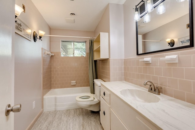 107 Sage St, Lake Jackson, TX 77566 - full bath with shower / bath combo, wood finished floors, vanity, and tile walls