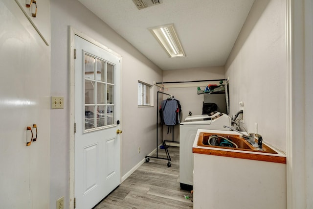 107 Sage St, Lake Jackson, TX 77566 - laundry room with light wood finished floors and independent washer and dryer