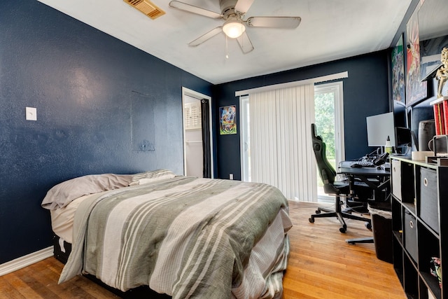 107 Sage St, Lake Jackson, TX 77566 - bedroom with an office area, light wood-style flooring, access to outside, and a ceiling fan