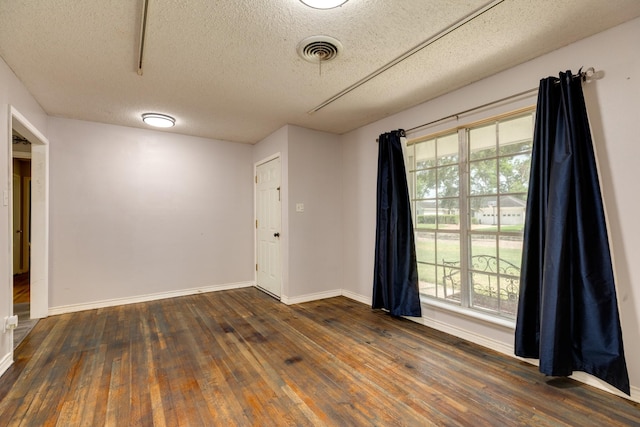 107 Sage St, Lake Jackson, TX 77566 - unfurnished room with a textured ceiling, dark wood-style flooring, and plenty of natural light