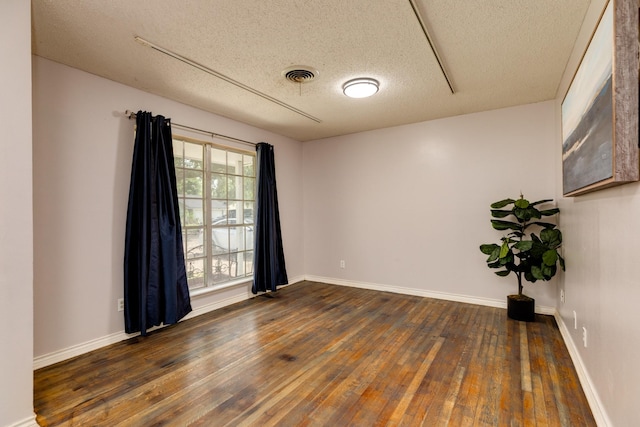 107 Sage St, Lake Jackson, TX 77566 - spare room featuring a textured ceiling and dark wood-style flooring