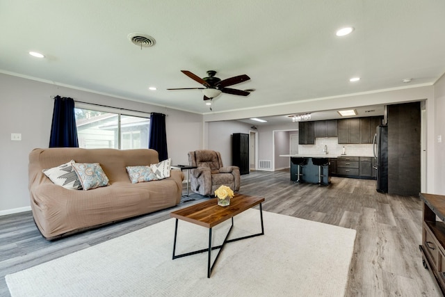 107 Sage St, Lake Jackson, TX 77566 - living area with light wood-type flooring, crown molding, ceiling fan, and recessed lighting