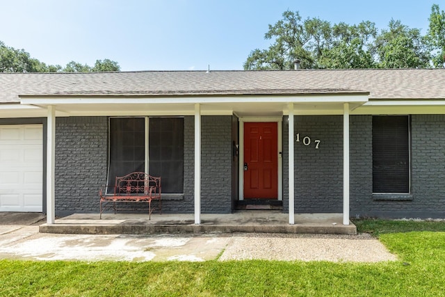 107 Sage St, Lake Jackson, TX 77566 - property entrance featuring covered porch and brick siding