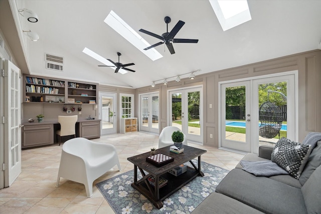 1643 Fall Valley Dr, Houston, TX 77077 - living room featuring french doors, a skylight, track lighting, high vaulted ceiling, and light tile patterned floors