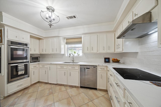 1643 Fall Valley Dr, Houston, TX 77077 - kitchen featuring stainless steel appliances, under cabinet range hood, a chandelier, backsplash, and ornamental molding