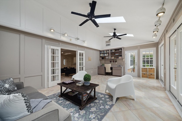1643 Fall Valley Dr, Houston, TX 77077 - living area with a decorative wall, french doors, lofted ceiling, a desk, and a skylight