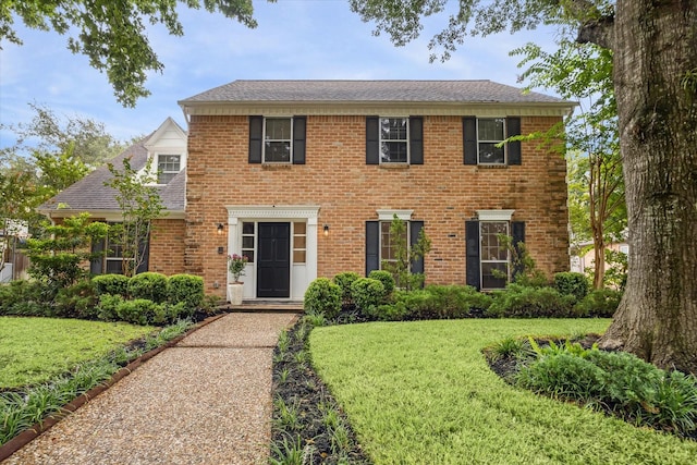 1643 Fall Valley Dr, Houston, TX 77077 - colonial-style house with a front yard and a shingled roof