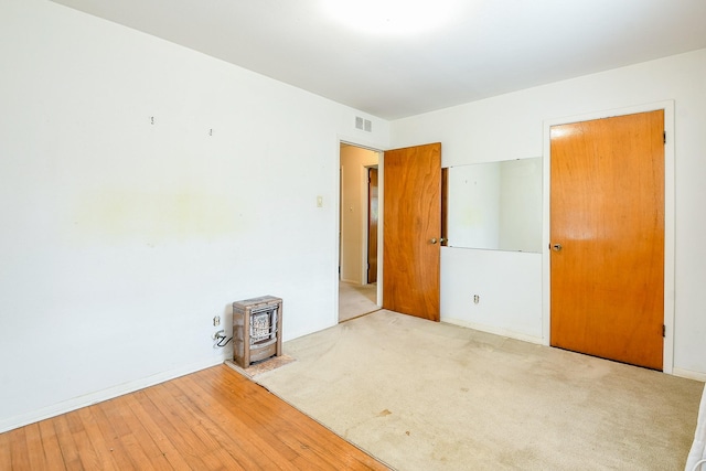 7111 Oak Village Dr, Houston, TX 77396 - unfurnished bedroom featuring a wood stove and wood finished floors