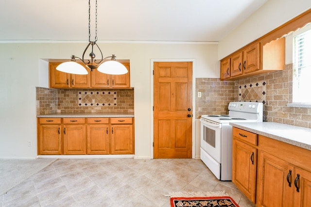 7111 Oak Village Dr, Houston, TX 77396 - kitchen with electric stove, light countertops, backsplash, brown cabinets, and crown molding