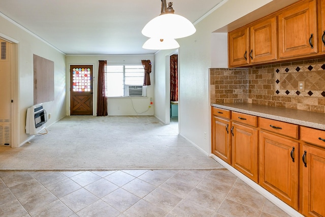 7111 Oak Village Dr, Houston, TX 77396 - kitchen with heating unit, light colored carpet, brown cabinetry, and crown molding