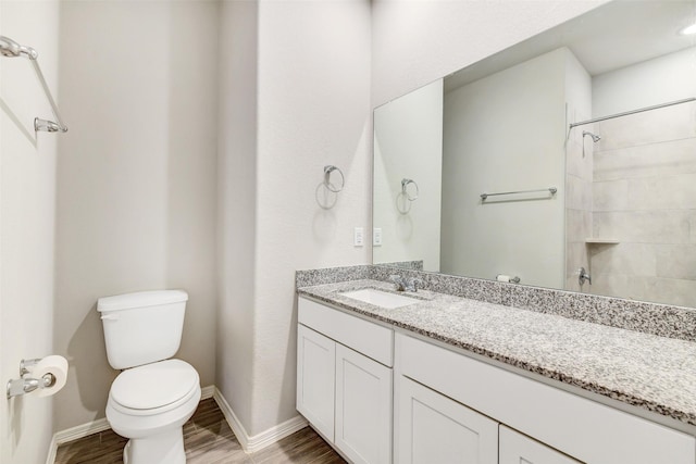 25707 Boxwood Hedge Ln, Tomball, TX 77375 - bathroom with vanity, wood finished floors, and a tile shower
