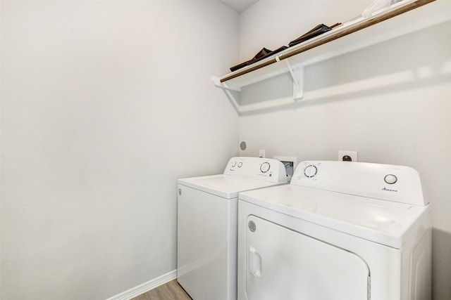 25707 Boxwood Hedge Ln, Tomball, TX 77375 - laundry room featuring washing machine and dryer and light wood finished floors