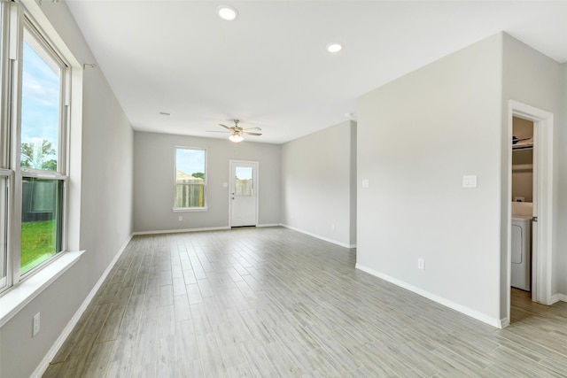 25707 Boxwood Hedge Ln, Tomball, TX 77375 - unfurnished living room with a ceiling fan, recessed lighting, light wood-type flooring, and washer / dryer