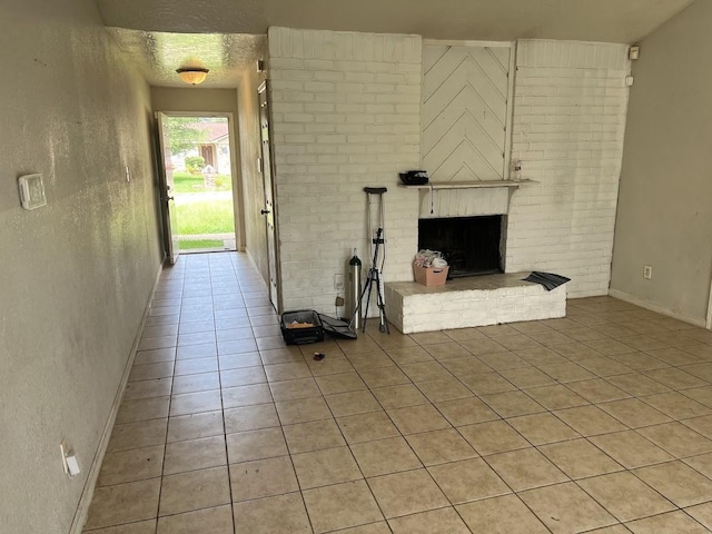 8611 Sherrywood Dr, Houston, TX 77044 - unfurnished living room with light tile patterned floors and a fireplace