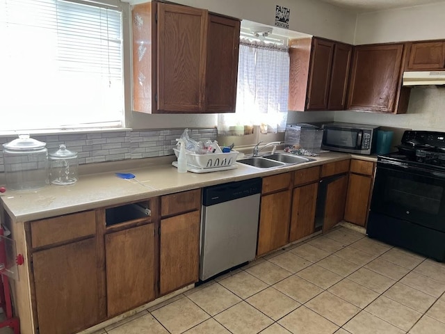 8611 Sherrywood Dr, Houston, TX 77044 - kitchen with stainless steel dishwasher, black electric range, under cabinet range hood, and plenty of natural light