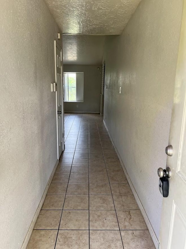 8611 Sherrywood Dr, Houston, TX 77044 - hall with a textured wall, light tile patterned floors, and a textured ceiling