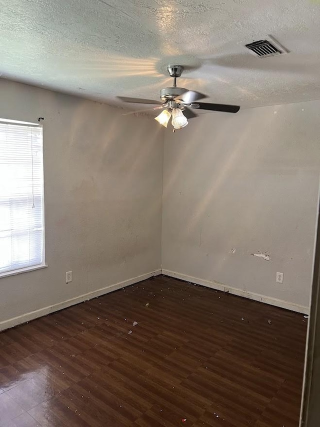 8611 Sherrywood Dr, Houston, TX 77044 - empty room featuring a ceiling fan, dark wood finished floors, and a textured ceiling