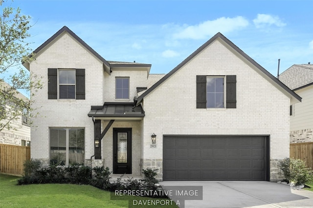 5021 Steady Breeze Dr, Katy, TX 77493 - french country inspired facade featuring a garage, brick siding, and driveway