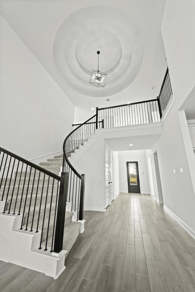 5021 Steady Breeze Dr, Katy, TX 77493 - entryway featuring wood finished floors, stairs, a high ceiling, a chandelier, and a tray ceiling