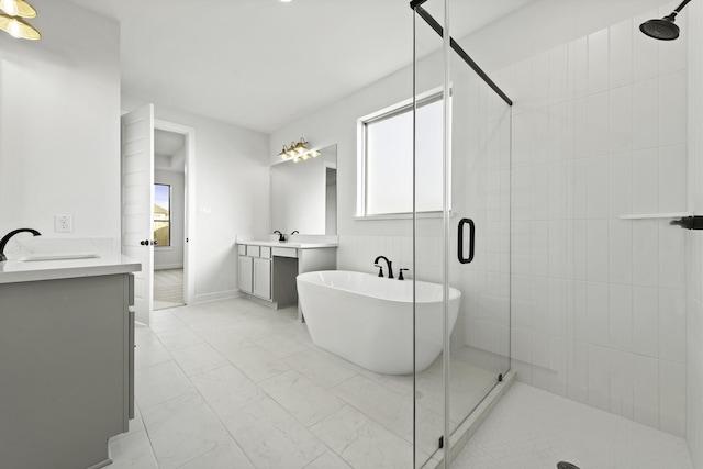 5021 Steady Breeze Dr, Katy, TX 77493 - full bathroom featuring two vanities, a stall shower, marble finish floors, and a soaking tub