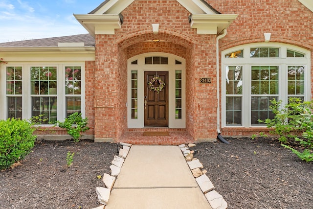 21403 Wild Jasmine Ln, Katy, TX 77450 - view of exterior entry with brick siding and a shingled roof