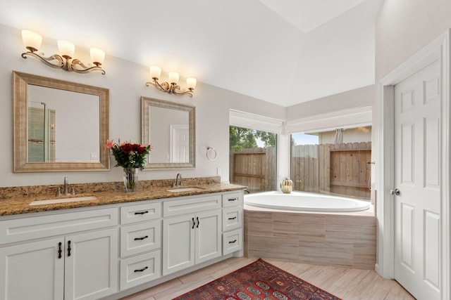 21403 Wild Jasmine Ln, Katy, TX 77450 - bathroom featuring double vanity, a bath, tile patterned flooring, and high vaulted ceiling