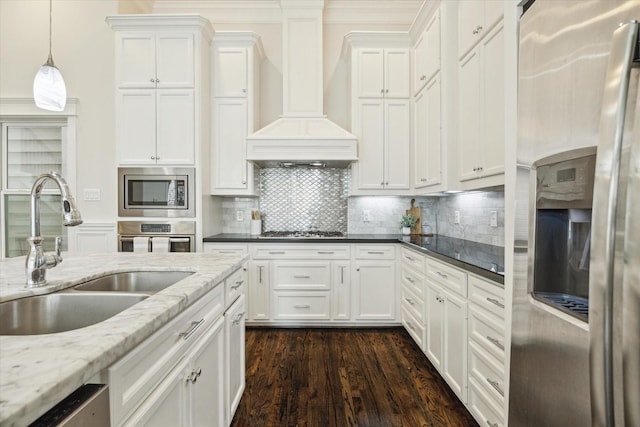 2108 Bidwell Dr, Houston, TX 77018 - kitchen with stainless steel appliances, premium range hood, white cabinets, dark wood finished floors, and tasteful backsplash