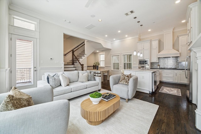 2108 Bidwell Dr, Houston, TX 77018 - living area with crown molding, stairs, dark wood-style floors, a wainscoted wall, and recessed lighting