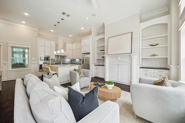 2108 Bidwell Dr, Houston, TX 77018 - living area featuring dark wood-style floors, crown molding, recessed lighting, and built in shelves